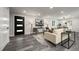 A bright living room featuring modern finishes and neutral decor, and a stylish front door at 9591 W Florida Pl, Lakewood, CO 80232