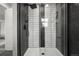 Contemporary shower with glass enclosure and modern tilework, creating a spa-like retreat at 9591 W Florida Pl, Lakewood, CO 80232