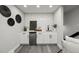 Contemporary wet bar with subway tile backsplash, mini fridge, and sleek fixtures at 9591 W Florida Pl, Lakewood, CO 80232