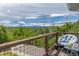 Relaxing balcony with a comfortable chair and a breathtaking view of the surrounding mountains and lush greenery at 6260 Everett Ct # D, Arvada, CO 80004
