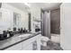 Modern bathroom with stylish gray countertops, updated fixtures, and a shower-tub combination, offers a sleek design at 6260 Everett Ct # D, Arvada, CO 80004