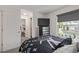 Bright bedroom with a view, TV, modern closet, and stylish decor for a comfortable living space at 6260 Everett Ct # D, Arvada, CO 80004