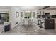 Bright dining room with round table, white chairs, and modern chandelier near the kitchen at 6260 Everett Ct # D, Arvada, CO 80004