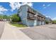 Exterior of a row of charming blue townhomes, each with private balconies and attached garages for convenient parking at 6260 Everett Ct # D, Arvada, CO 80004