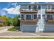 Exterior of a townhome building with multiple levels of private balconies and attached garages for convenient parking at 6260 Everett Ct # D, Arvada, CO 80004