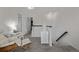 Bright hallway with cozy armchair and stairs leading down at 6260 Everett Ct # D, Arvada, CO 80004