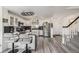 Well-lit kitchen with stainless steel appliances, breakfast bar, and staircase at 6260 Everett Ct # D, Arvada, CO 80004