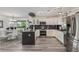 Open kitchen with white cabinets, stainless steel appliances, and dark countertops at 6260 Everett Ct # D, Arvada, CO 80004