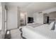 Bright main bedroom with ensuite bathroom, plush carpet, and access to walk-in closet via sliding French doors at 6260 Everett Ct # D, Arvada, CO 80004