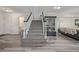 Open staircase design showcasing modern lighting and decor elements, creating a stylish transition at 6260 Everett Ct # D, Arvada, CO 80004