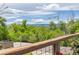 Balcony showcasing a stunning view of lush greenery and distant mountains, blending nature and suburban serenity at 6260 Everett Ct # D, Arvada, CO 80004