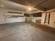 View of a garage showing the concrete floor, overhead lighting, and extra storage space at 1203 S Crystal Way, Aurora, CO 80012