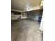 Spacious garage featuring a concrete floor, overhead lighting, and additional storage space at 1203 S Crystal Way, Aurora, CO 80012
