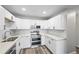 Kitchen with stainless steel oven, sink, white cabinets, and countertops at 495 S Dayton St # 1D, Denver, CO 80247