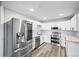 Kitchen featuring stainless steel appliances, white cabinets, and modern countertops at 495 S Dayton St # 1D, Denver, CO 80247