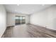 Spacious living room with new flooring and sliding glass doors to a balcony at 495 S Dayton St # 1D, Denver, CO 80247