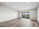 Spacious living room with new flooring and sliding glass doors to a balcony at 495 S Dayton St # 1D, Denver, CO 80247