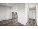 Open-concept living area with modern flooring, stainless steel fridge, and updated kitchen at 495 S Dayton St # 1D, Denver, CO 80247