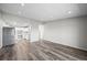 Open-concept living space showcasing hardwood floors and a glimpse of the kitchen at 495 S Dayton St # 1D, Denver, CO 80247