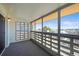 Enclosed patio with carpeted floor and a neighborhood view through the windows at 495 S Dayton St # 1D, Denver, CO 80247