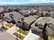 An aerial view displaying the house's location and landscaping in a neighborhood with mature trees and views of the mountains at 5541 S Eaton St, Littleton, CO 80123