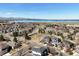 Picturesque aerial view of a residential neighborhood with a lake and mountain backdrop at 5541 S Eaton St, Littleton, CO 80123