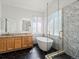 This primary bathroom has a soaking tub, step-in shower, and granite counters at 5541 S Eaton St, Littleton, CO 80123