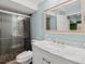 Stylish bathroom featuring a white vanity with granite countertop and tiled glass shower enclosure at 5541 S Eaton St, Littleton, CO 80123