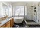 This bathroom features a soaking tub, step-in shower, and granite counters at 5541 S Eaton St, Littleton, CO 80123