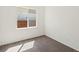 This bedroom offers a neutral palette, large window and carpet at 5541 S Eaton St, Littleton, CO 80123