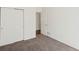 This bedroom has neutral carpet, closet with double doors, and an open doorway at 5541 S Eaton St, Littleton, CO 80123