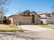 Attractive single-Gathering home showcasing a well-maintained lawn, mature trees, and a two-car garage at 5541 S Eaton St, Littleton, CO 80123