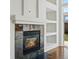 Living room with a fireplace and built in shelving for decor and displaying treasured belongings at 5541 S Eaton St, Littleton, CO 80123