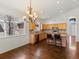 Kitchen with breakfast bar, hardwood floors, wood cabinets, stainless steel appliances, and a chandelier at 5541 S Eaton St, Littleton, CO 80123