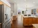 Open-concept kitchen featuring a large island, stainless steel appliances, and seamless flow to dining area at 5541 S Eaton St, Littleton, CO 80123