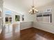 Spacious living room features hardwood floors, a vaulted ceiling, a chandelier, and an abundance of natural light at 5541 S Eaton St, Littleton, CO 80123