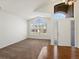 Inviting living area featuring large windows, neutral decor, and a smooth transition to hardwood flooring at 5541 S Eaton St, Littleton, CO 80123