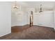 Bright, open-concept living area with hardwood flooring and decorative light fixtures at 5541 S Eaton St, Littleton, CO 80123