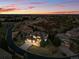 Aerial view of a beautiful home with a three-car garage, lush lawn, and inviting outdoor fire pit at 6577 Esperanza Dr, Castle Pines, CO 80108