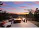 Relaxing backyard stone patio with comfortable furniture, fireplace heater, and scenic view at 6577 Esperanza Dr, Castle Pines, CO 80108