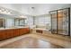 Bright primary bathroom with dual vanity, soaking tub, and glass shower at 6577 Esperanza Dr, Castle Pines, CO 80108