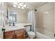 Neutral bathroom with wood vanity and shower/tub combination at 6577 Esperanza Dr, Castle Pines, CO 80108