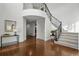 Grand two-story foyer featuring gleaming hardwood floors, elegant staircase, and abundant natural light at 6577 Esperanza Dr, Castle Pines, CO 80108