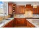 Well-equipped kitchen featuring stone countertops, custom cabinets, backsplash and modern appliances at 6577 Esperanza Dr, Castle Pines, CO 80108