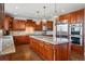 Gourmet kitchen with custom cabinets, granite countertops, stainless steel appliances and large island at 6577 Esperanza Dr, Castle Pines, CO 80108