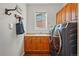 Functional laundry room with modern washer and dryer, ample cabinet space, and a practical sink area at 6577 Esperanza Dr, Castle Pines, CO 80108