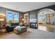 Open living room with fireplace, view, and access to the primary bathroom at 6577 Esperanza Dr, Castle Pines, CO 80108