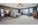 Serene main bedroom suite with tray ceiling, large windows, and a sitting area at 6577 Esperanza Dr, Castle Pines, CO 80108