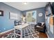 Comfortable home office with natural light, a white desk, and stylish decor with a view at 6577 Esperanza Dr, Castle Pines, CO 80108