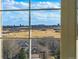 Window view overlooking rolling hills and distant mountains, showcasing natural beauty at 6577 Esperanza Dr, Castle Pines, CO 80108